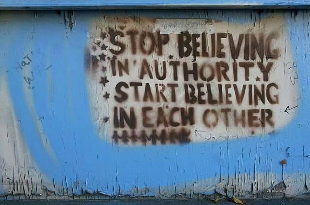 Graffiti: "Stop believing in authority - Start believing in each other"