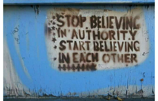 Graffiti: "Stop believing in authority - Start believing in each other"